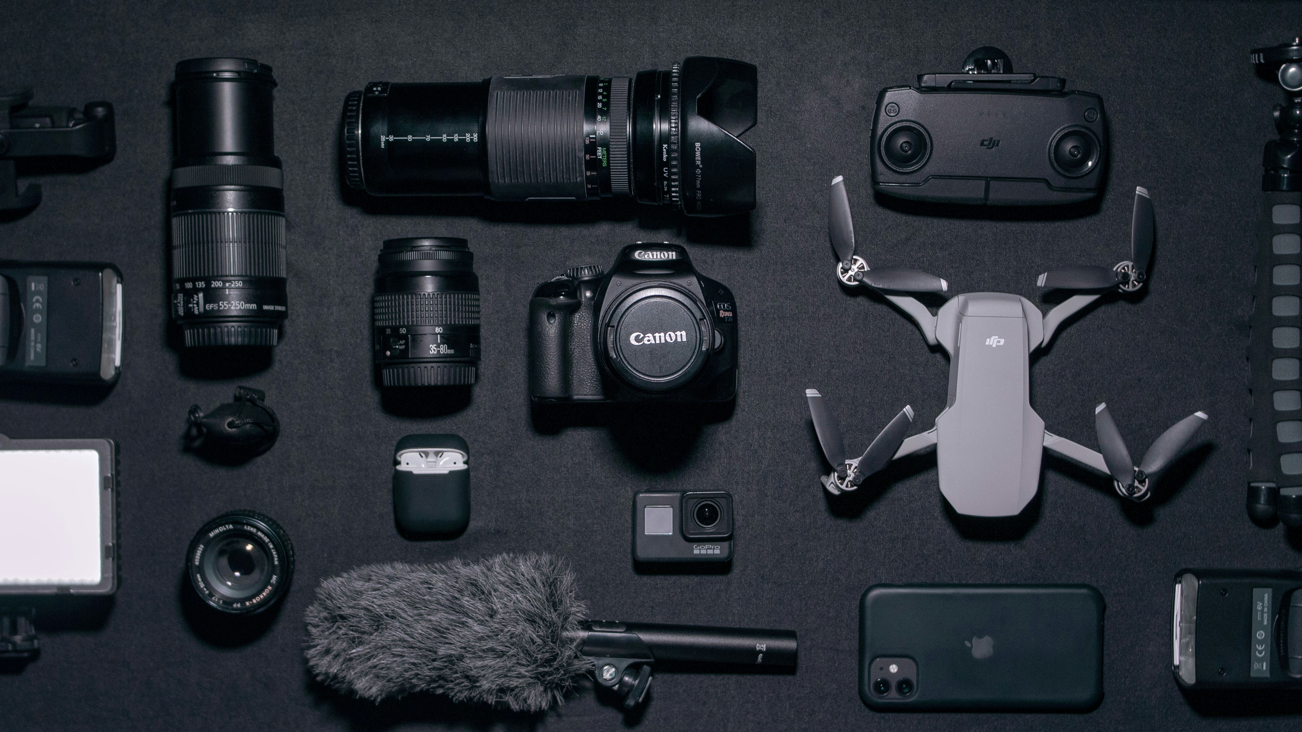 photographic equipment black camera drone cell phone flash tripie airpods lenses